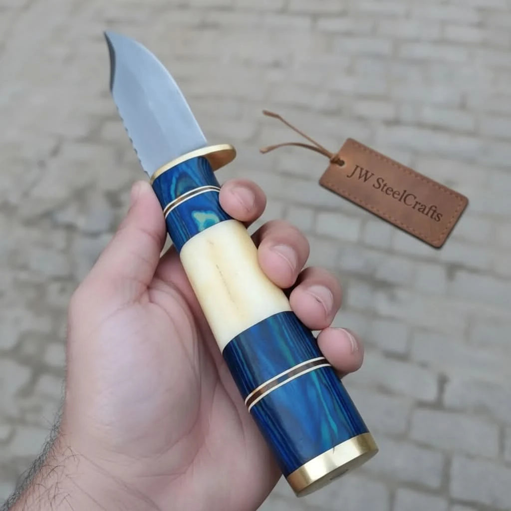 Forest Bowie knife with polished steel blade, blue handle accents, brass guard, and rustic tree stump background
