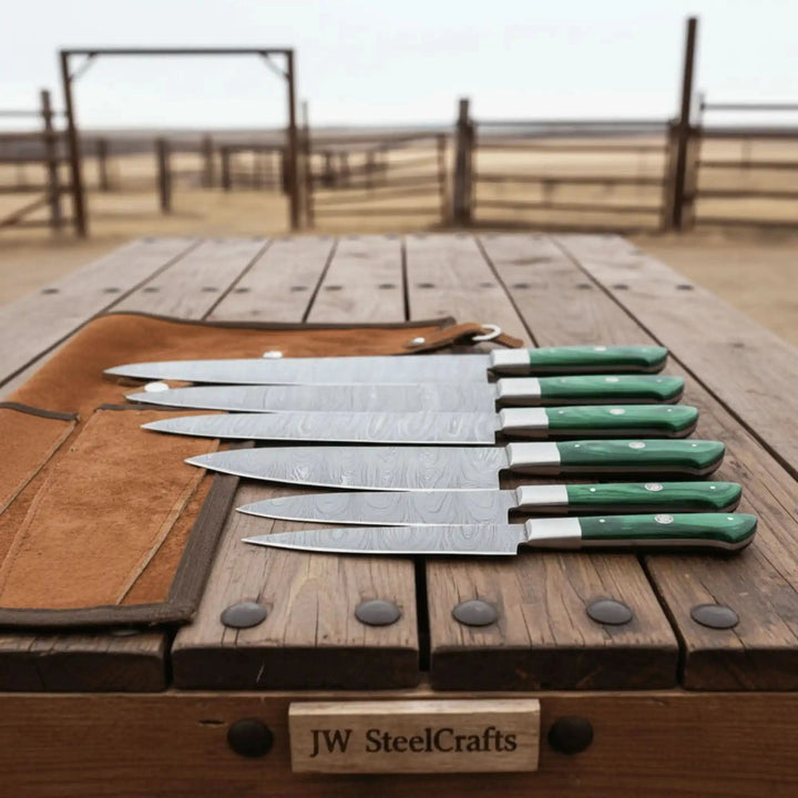 Luxury Damascus kitchen cutlery arranged neatly to highlight varied blade profiles and artisan finishing quality.