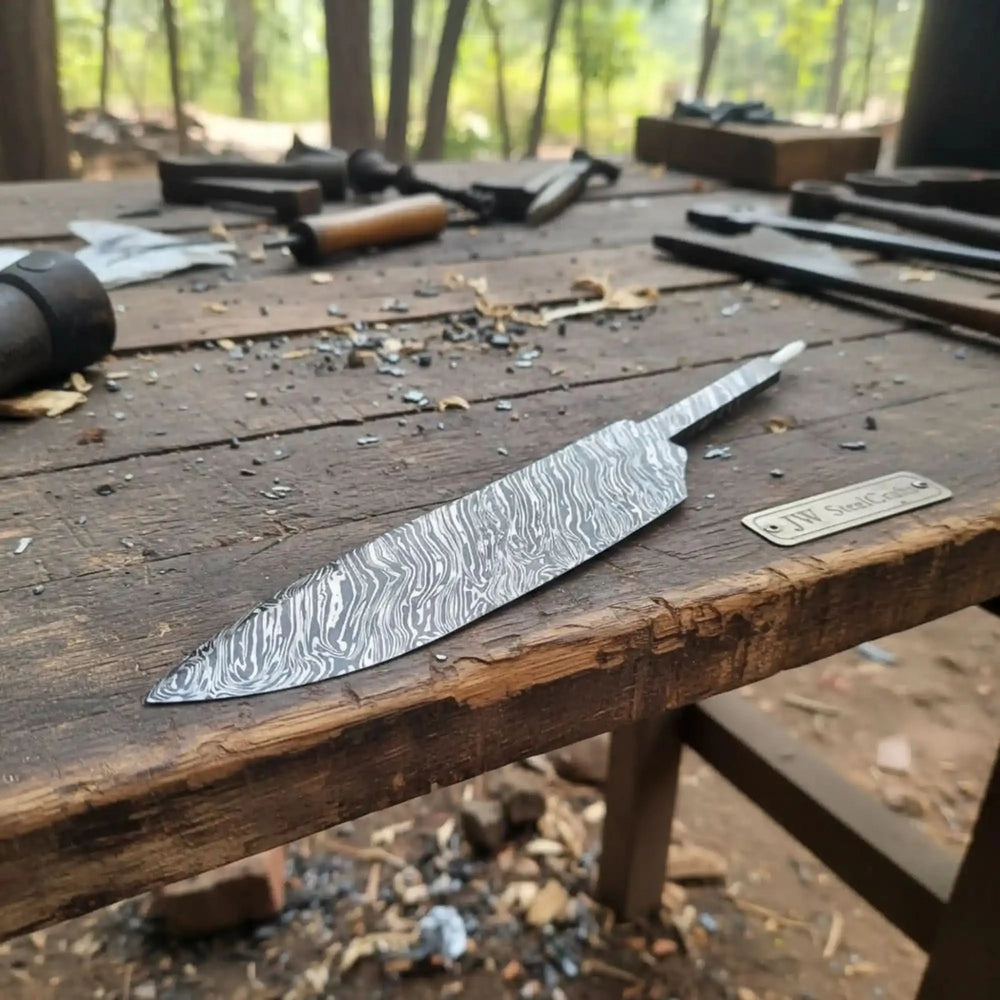 Damascus steel knife on a wooden workbench with tools in the background