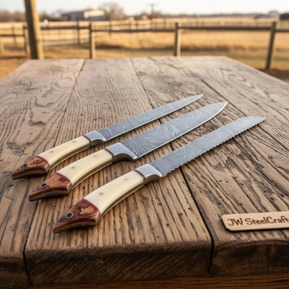 Handmade kitchen Damascus knives with resin handles and patterned steel blades.