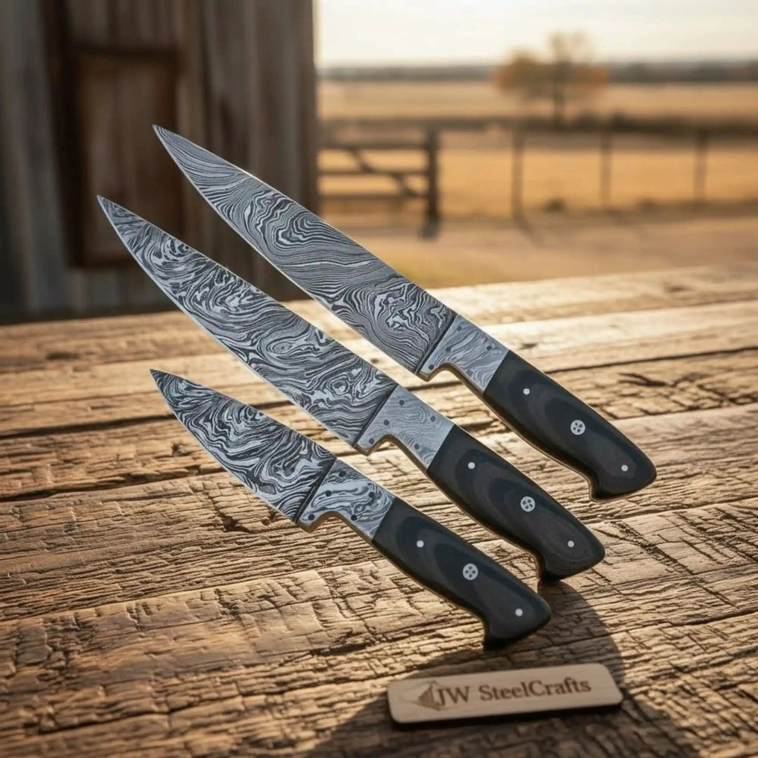 Handmade kitchen knives crafted from Damascus steel with smooth polished black handles.