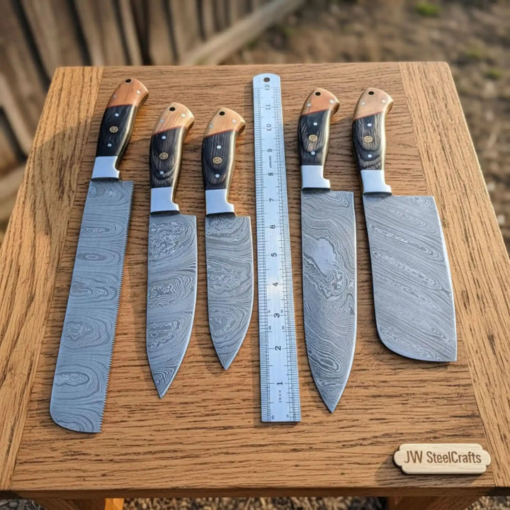Top-down size reference of JW SteelCrafts Damascus multi-blade knife collection with elegant black brown pakkawood handles and polished silver bolsters beside ruler on outdoor oak surface
