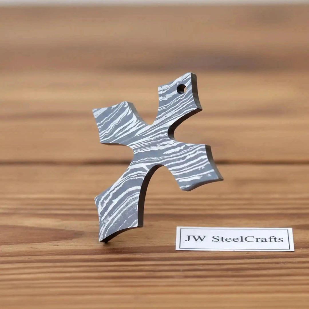 Damascus Steel Christian Cross Pendant Locket Metal Cross-Shaped Object On A Wooden Surface
