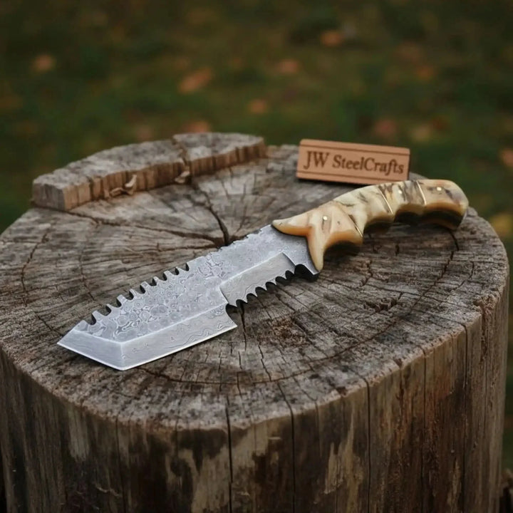 Damascus Tracker Knife With Ram Horn Handle Serrated Knife With Wooden Handle On A Wooden Stump
