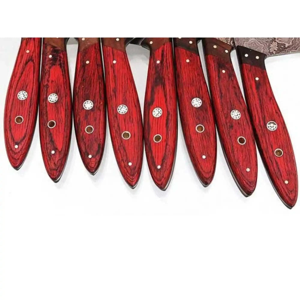 Premium cooking knives showcasing flowing Damascus wave patterns and polished metallic bolster detailing.