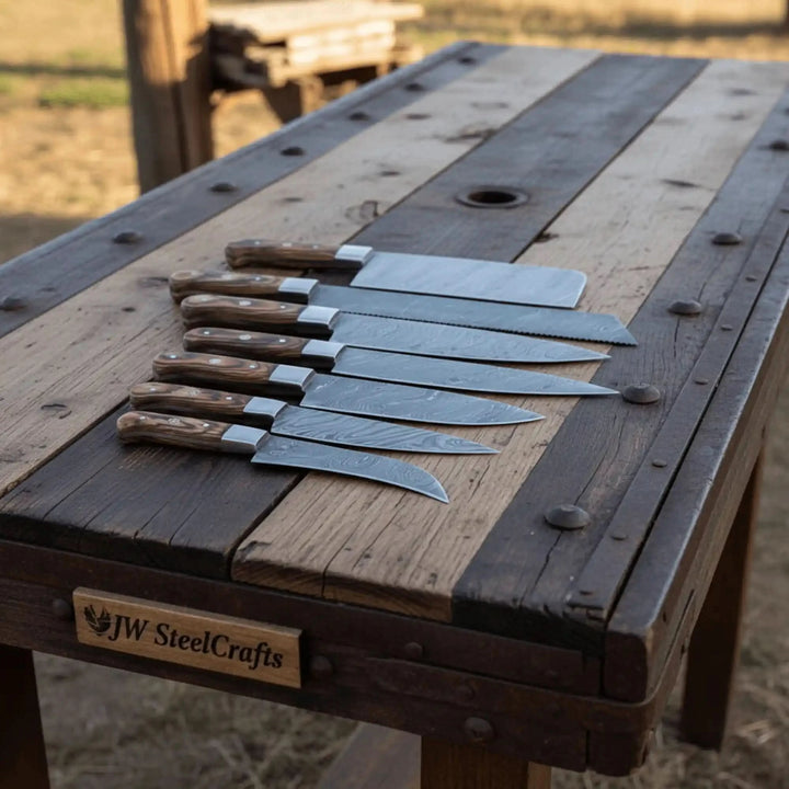 Countryside chef tools featuring polished silver bolsters and richly patterned reddish brown woodgrain handles.