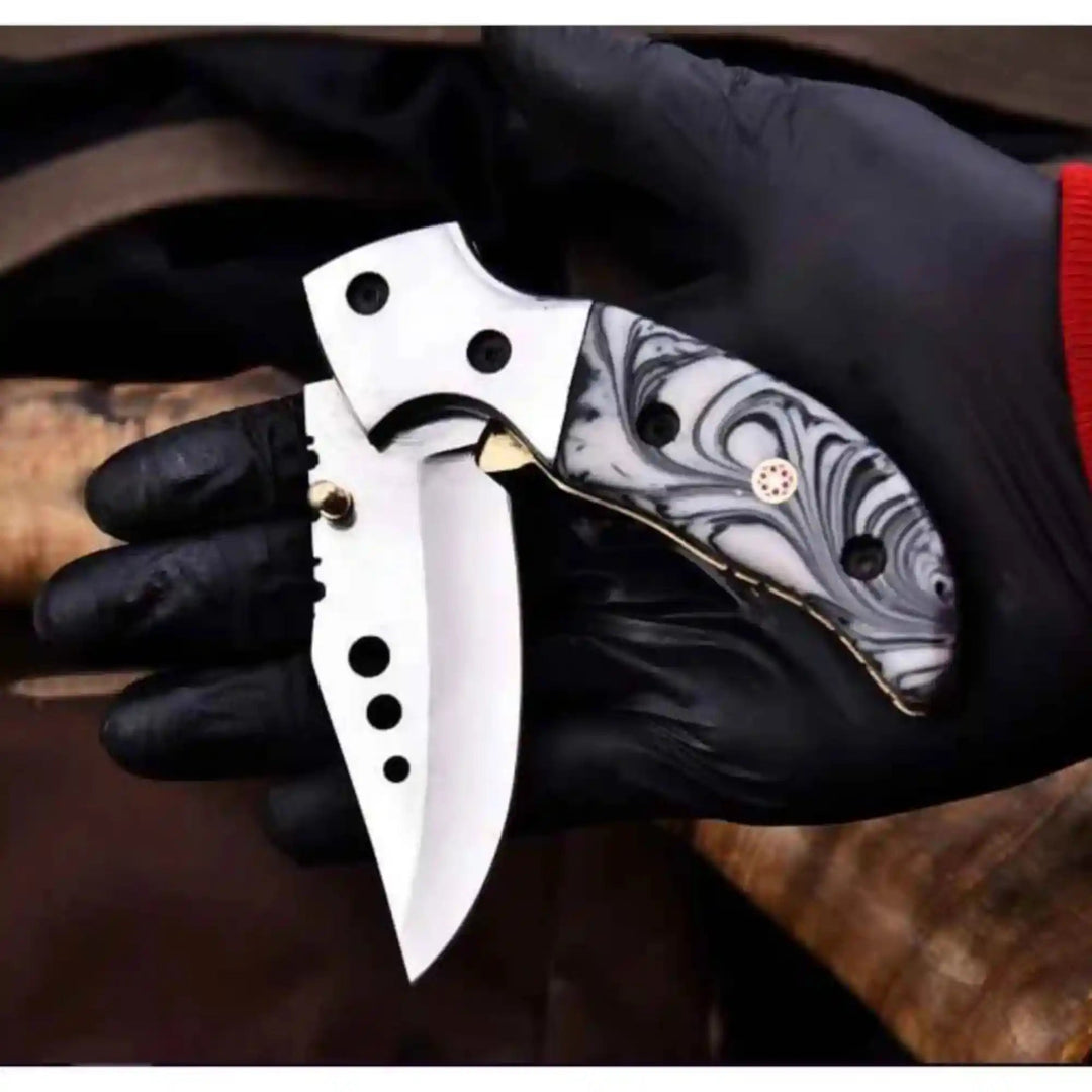     Aggressive mini tactical blade with resin scale style handle and modern folding mechanism