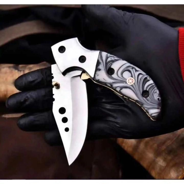     Aggressive mini tactical blade with resin scale style handle and modern folding mechanism