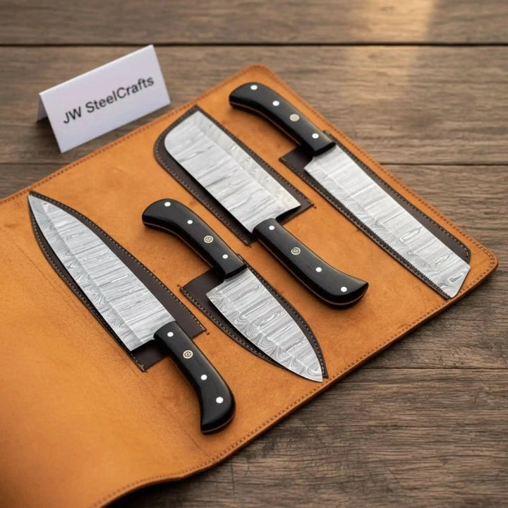Stainless steel chef knives with ebony wood handles displayed in leather roll organizer