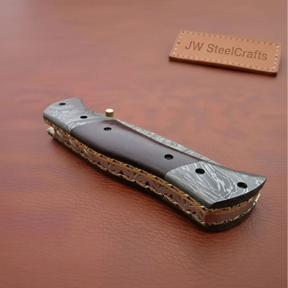     Collectible Damascus pocket knife showcasing unique blade patterns and polished handle construction
