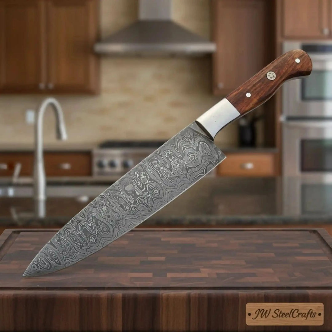 Textured Damascus chef cutter display with wooden handle and silver bolster detail