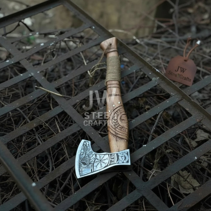 Closeup of precision engraved Norse rune pattern on Viking bearded axe steel head

