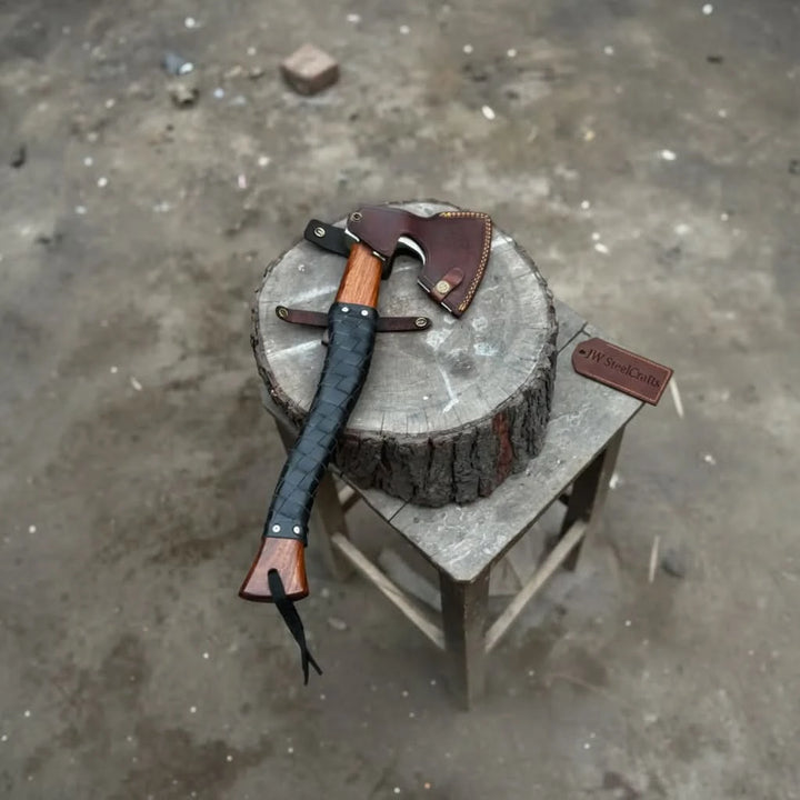 Frostshade-themed Norse camping hatchet featuring tactical leather wrapping and handcrafted wooden craftsmanship.