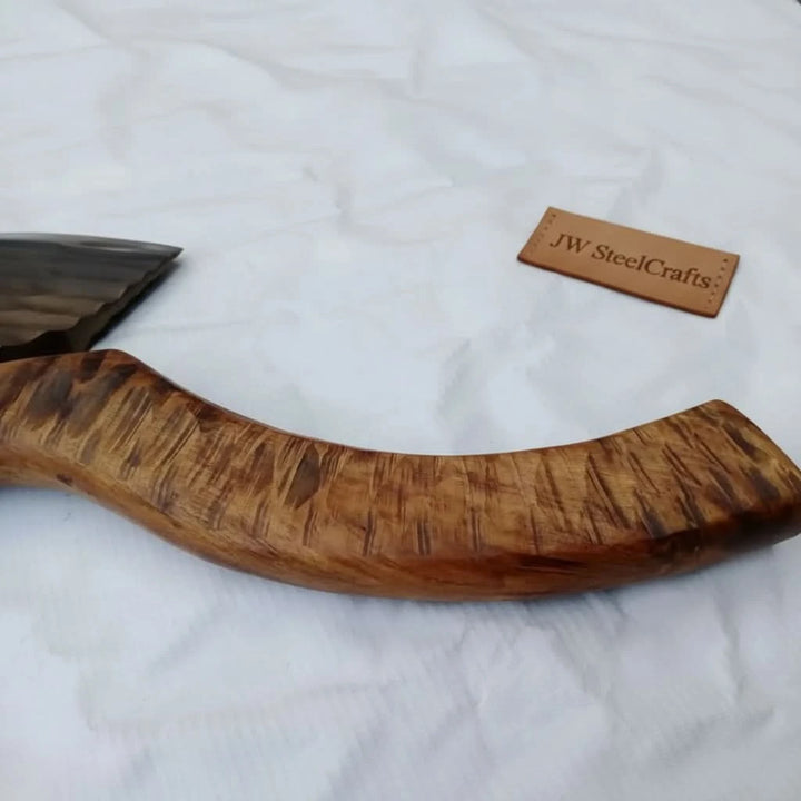 Falconveil-themed Norse woodland axe featuring forged steel blade ridges and rustic outdoor wood textures.