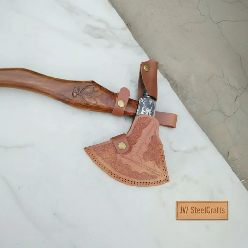 Eagle-inspired Viking Damascus hatchet displaying artistic steel engravings and premium handcrafted wood grip.