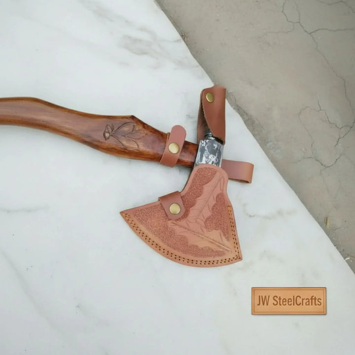 Eagle-inspired Viking Damascus hatchet displaying artistic steel engravings and premium handcrafted wood grip.