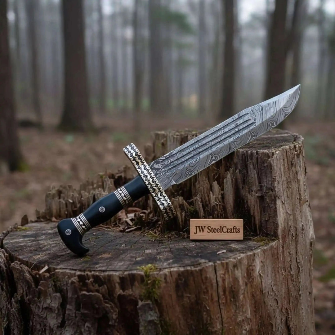     Medieval-inspired Damascus blade with carved guard and polished black ergonomic handle outdoors