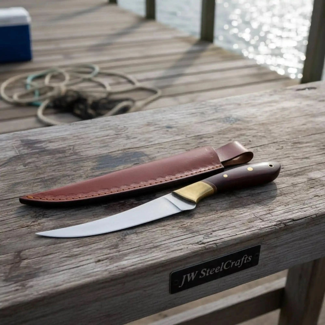 Fishing knife with brown leather cover and wooden handle placed on rustic deck boards