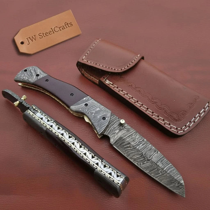     Custom Damascus steel folding knife featuring decorative handle details and secure locking mechanism