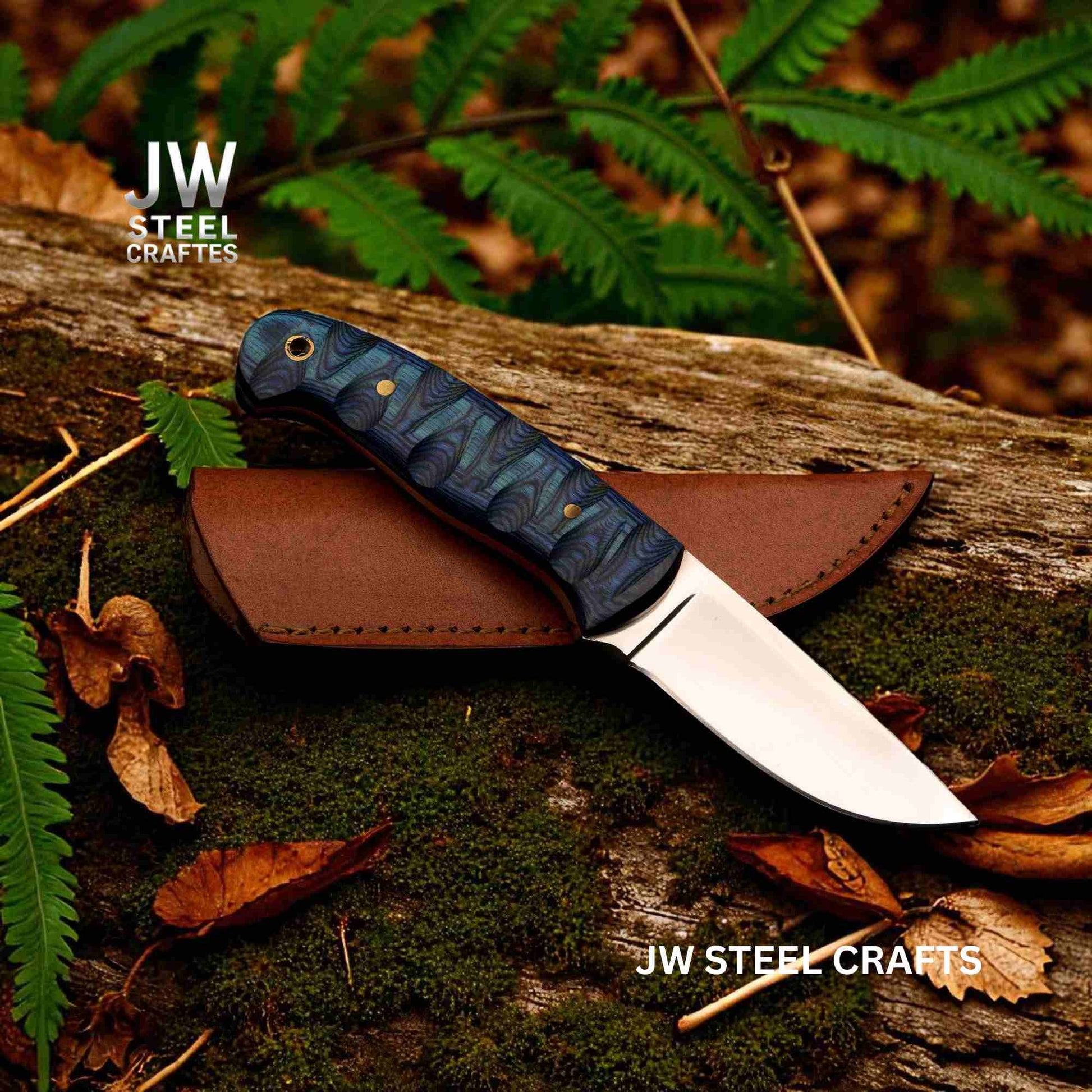 Knife with blue handle and brown sheath on a wooden log with ferns and leaves.