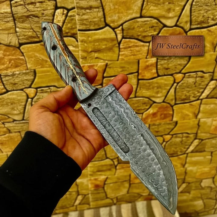 Heavy duty Damascus cleaver knife with wide blade, hand held display, black leather case, and textured wall background.