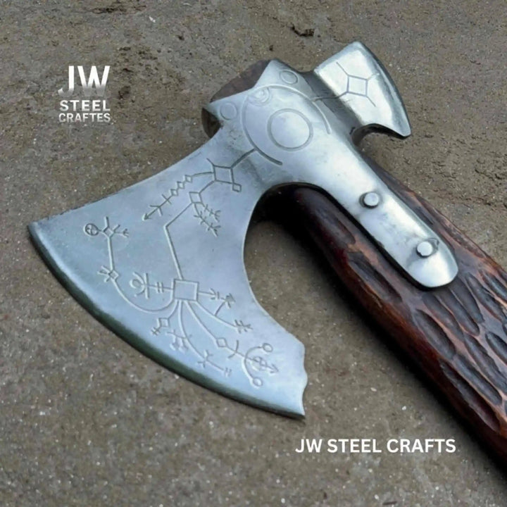 Closeup of Norse rune etching hand cut into carbon steel Viking double-bit axe head with engraved hardwood handle detail