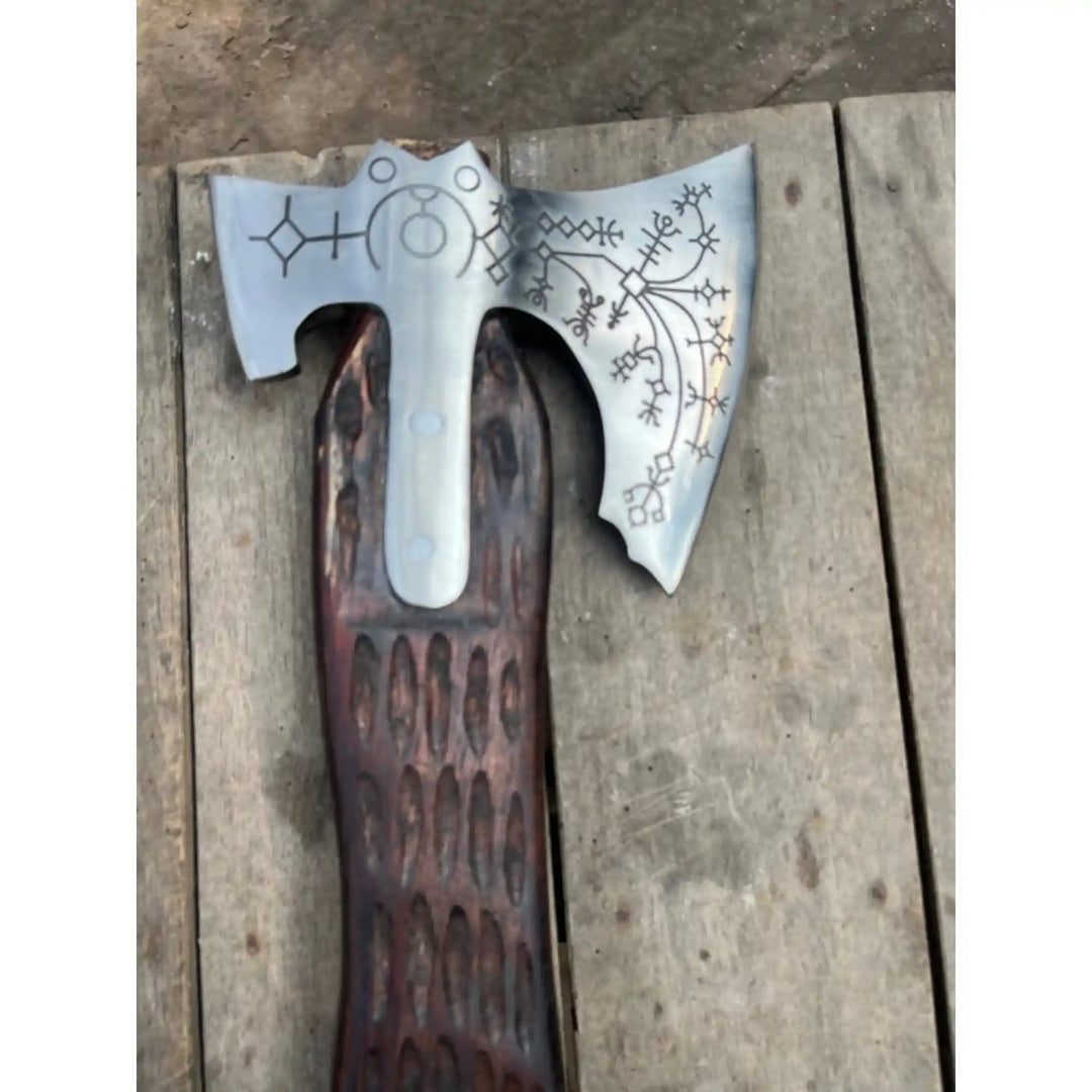 Hand forged JW SteelCrafts Viking double-bit axe displayed on a wooden surface with Norse rune detail visible