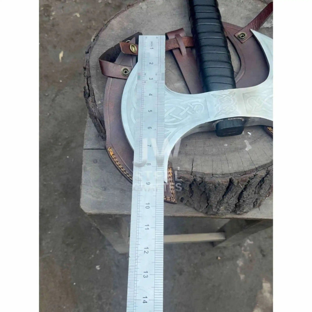 
JW SteelCrafts double-headed Viking axe with Nordic engravings displayed on a stone wall as collector centrepiece

