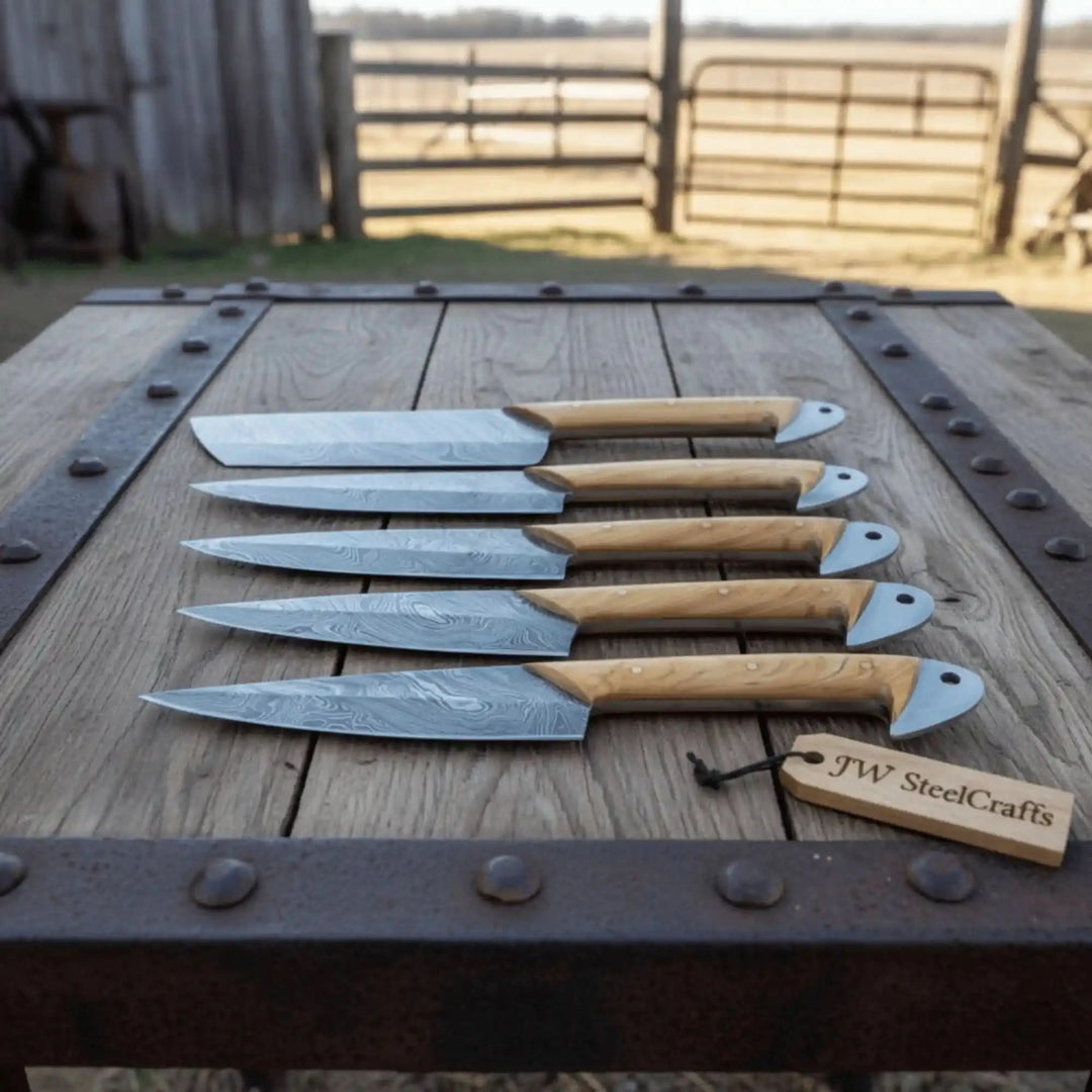 Handmade culinary cutlery displayed neatly on stone inspired background emphasizing luxury artisan construction and premium materials.