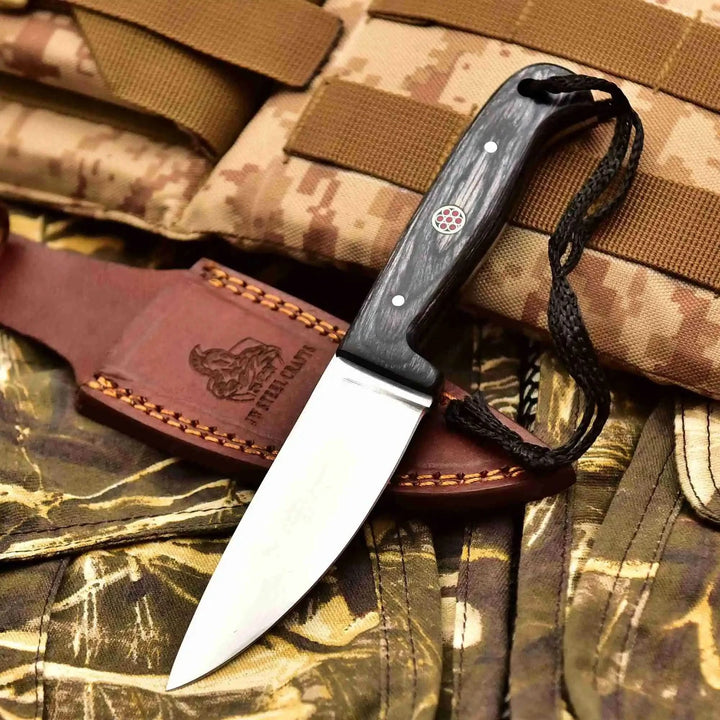 Polished blade knife set with leather holsters, colored handle scales, decorative pins, and outdoor tactical display.