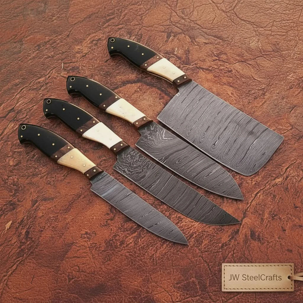 Top view of black bone handle Damascus chef knives displayed on rustic textured background.