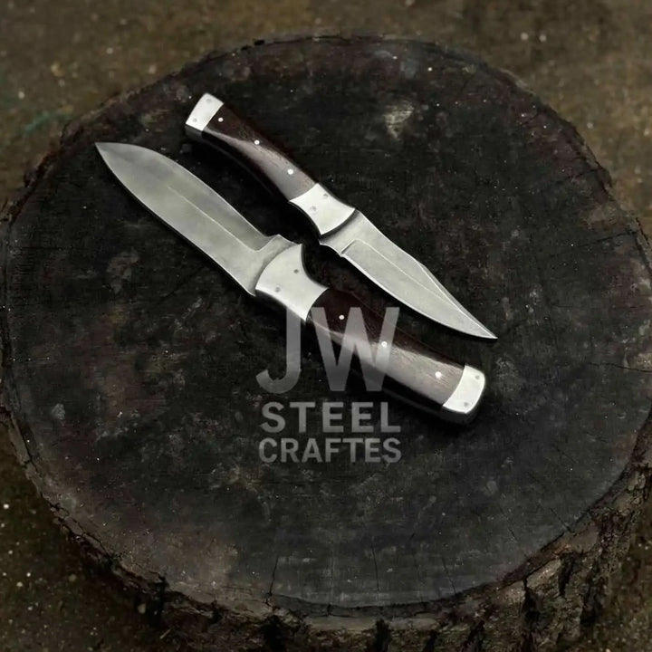 A carbon steel knives with ergonomic dark wood grips and silver bolsters, showcasing high-quality craftsmanship for professional culinary use.