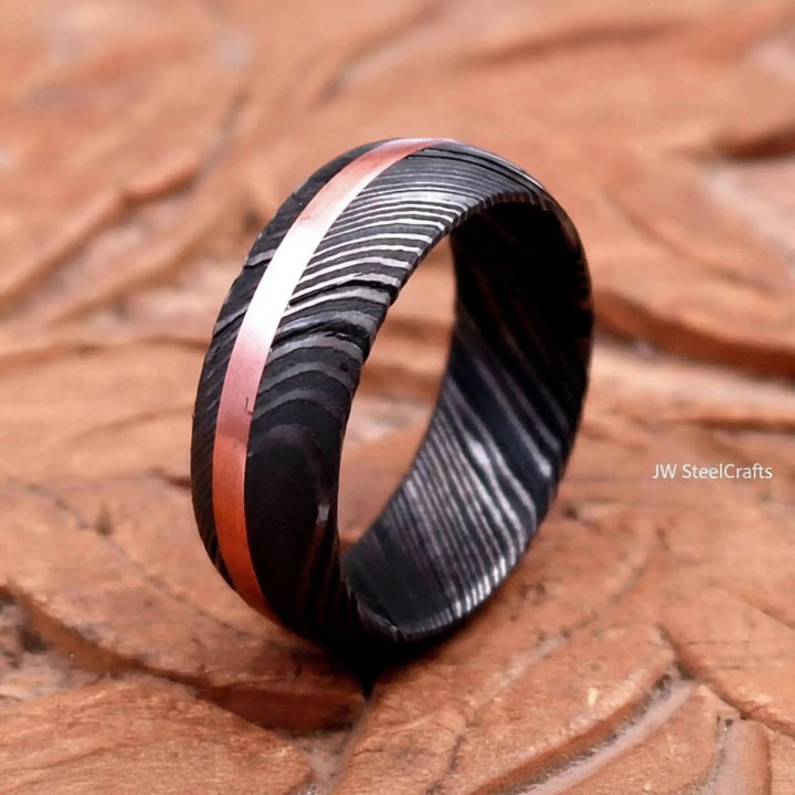 Handmade Damascus Ring Copper Inlay Black And Copper Ring On A Wooden Surface

