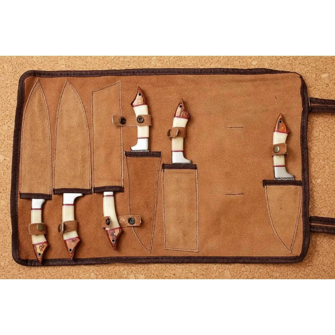 Steel Damascus kitchen knives with decorative blade detailing and leather storage case.