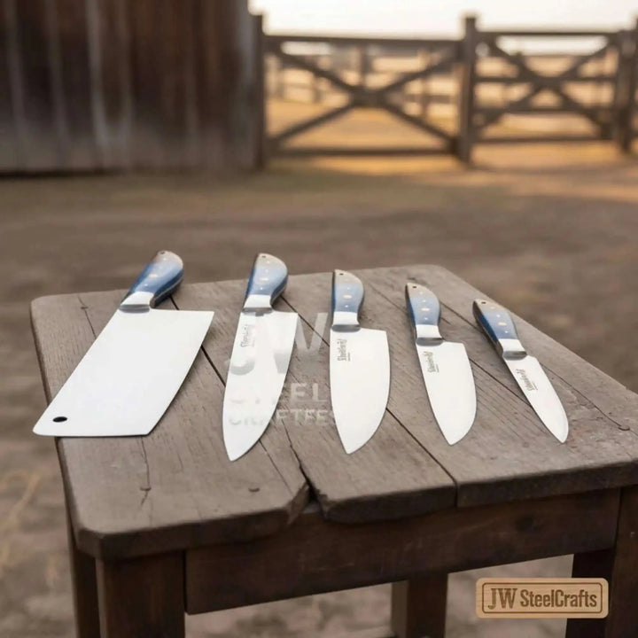 Premium 5 piece Damascus chef knives arranged in rustic countryside setting