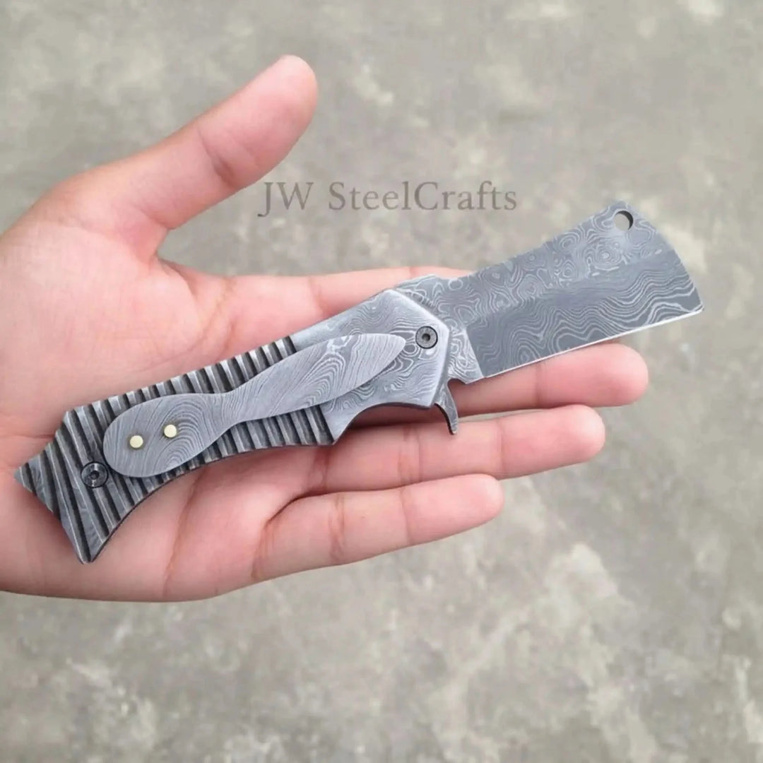 Handmade EDC Damascus Flipper Pocket Knife Folding Knife Held In A Hand With 'JW SteelCrafts' Branding.
