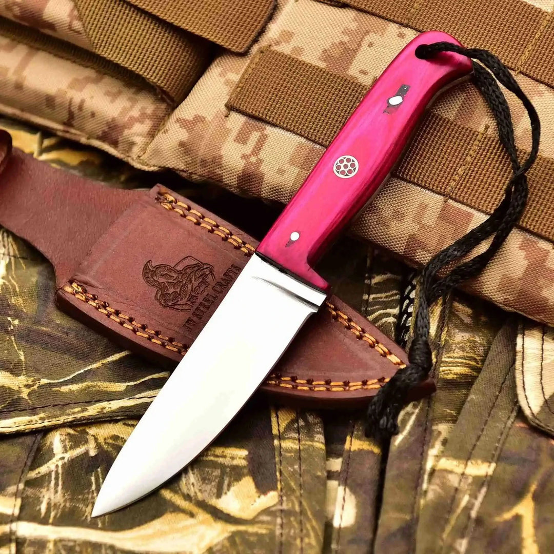 Rugged outdoor knife set with leather cases, three polished blades, pink black blue handles, and black lanyard cords.