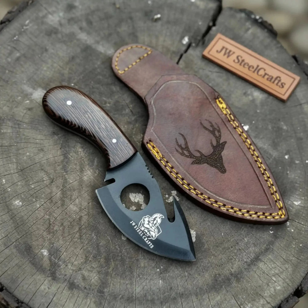 Handmade Fixed Blade Gut Hook Skinner Hunting Knife With Leather Sheath On A Wooden Surface
