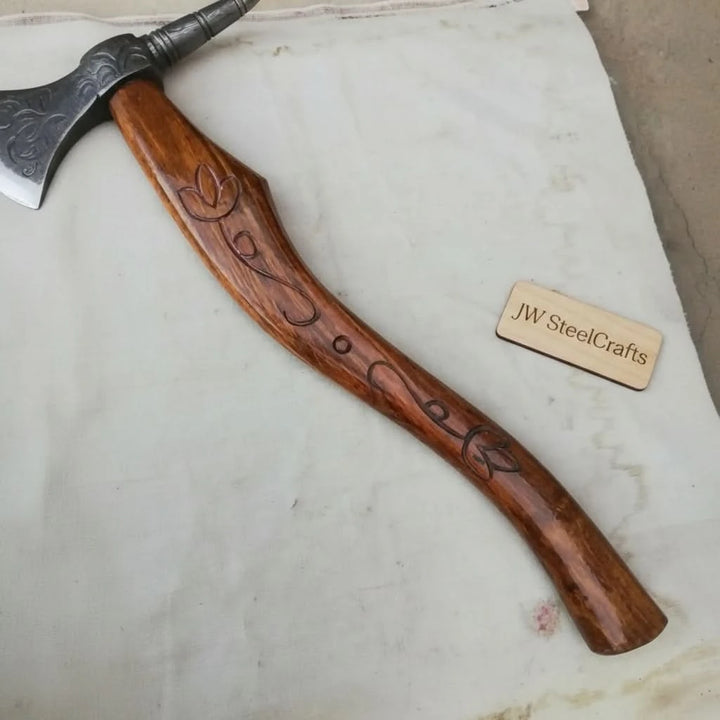 Glacier-inspired Viking outdoor axe showcasing decorative Damascus textures and ergonomic wooden handle craftsmanship.