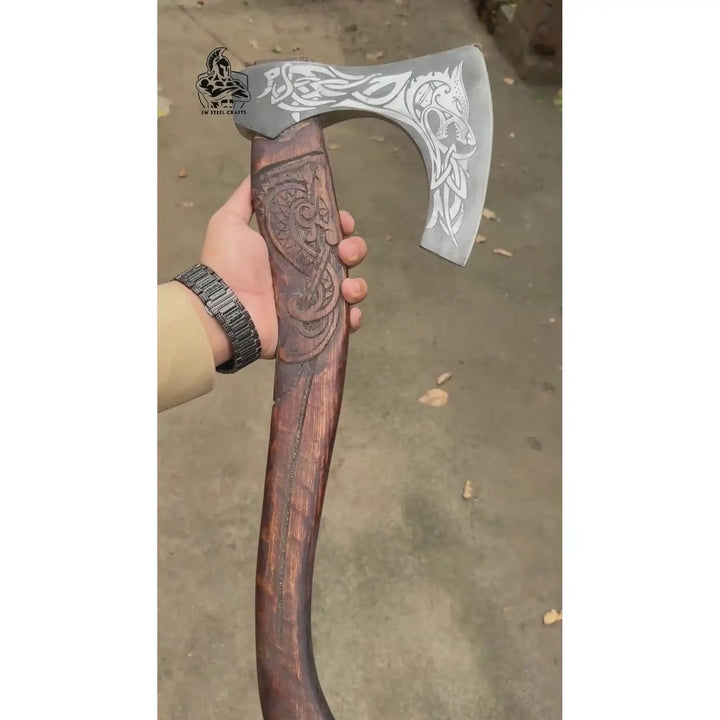 Gravewing-inspired Viking war hatchet with decorative Nordic raven engravings and handcrafted hardwood textures.