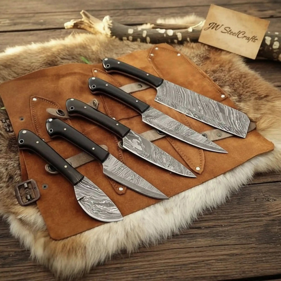 Rustic luxury Damascus cutlery set with precision-forged patterned steel blades and sophisticated black handle detailing.
