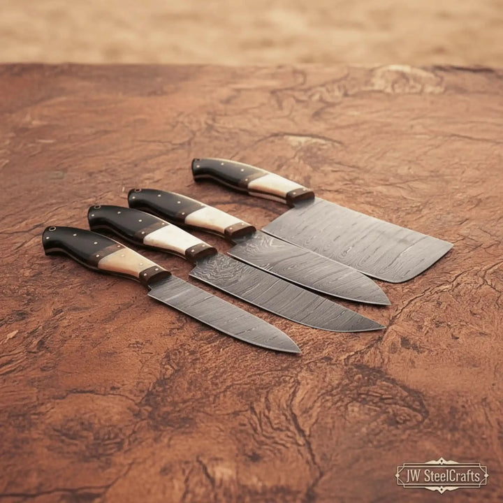 Professional Damascus kitchen knives arranged diagonally on textured rustic surface.