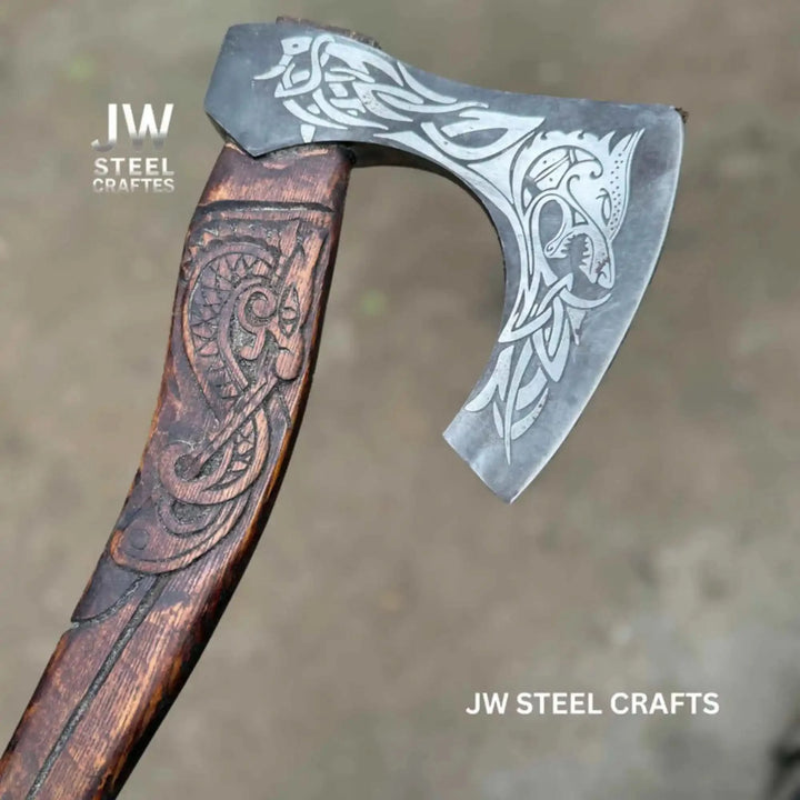 Ironraven-inspired Viking battle weapon featuring polished raven engravings and rustic handcrafted wood details.