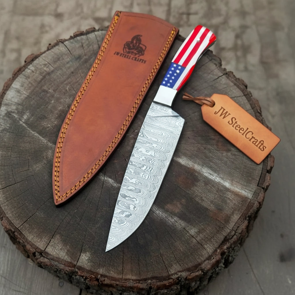 Forged Damascus chef knife with red white blue handle, patterned blade, and modern kitchen product photography.