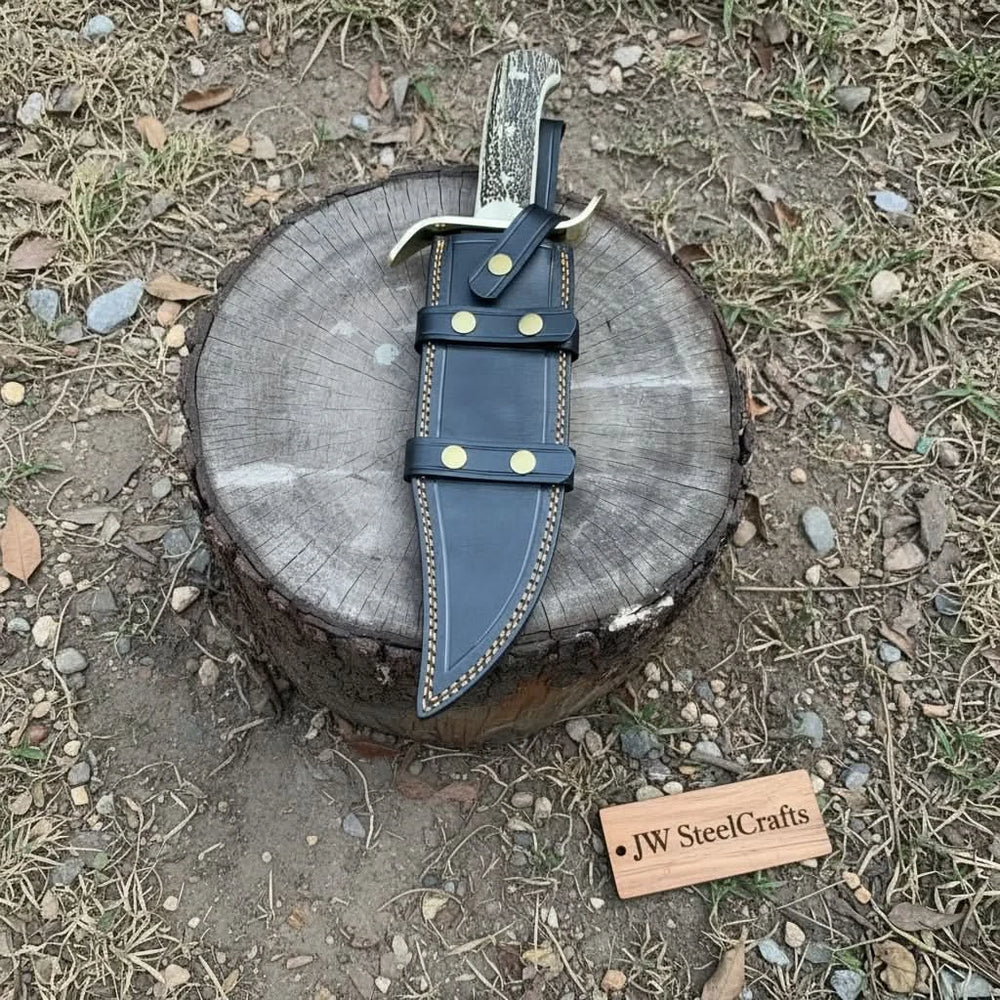 Heavy duty Bowie hunting knife with black sheath, brass guard, dark wood handle, and gut hook blade design.