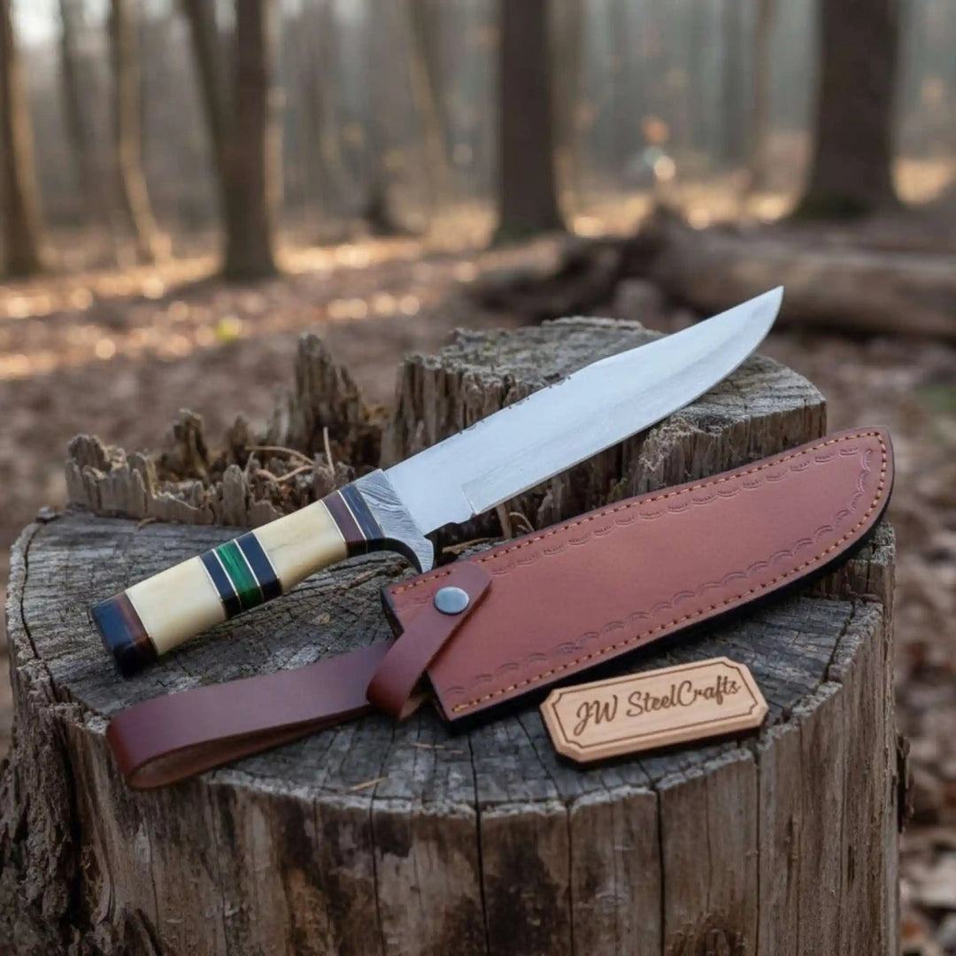 Bone handle Bowie knife with tan sheath, long curved blade, colored handle spacers, and stitched leather details.