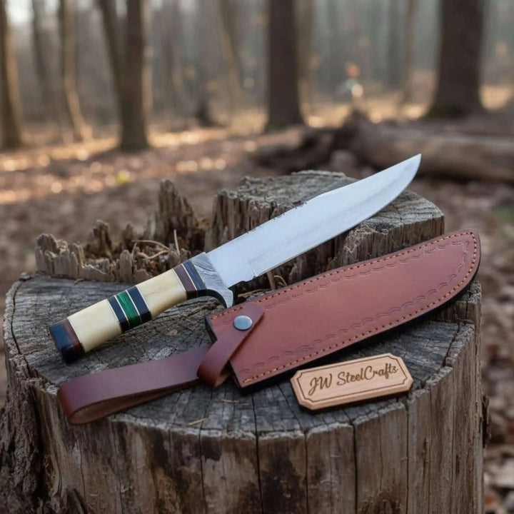 Bone handle Bowie knife with tan sheath, long curved blade, colored handle spacers, and stitched leather details.