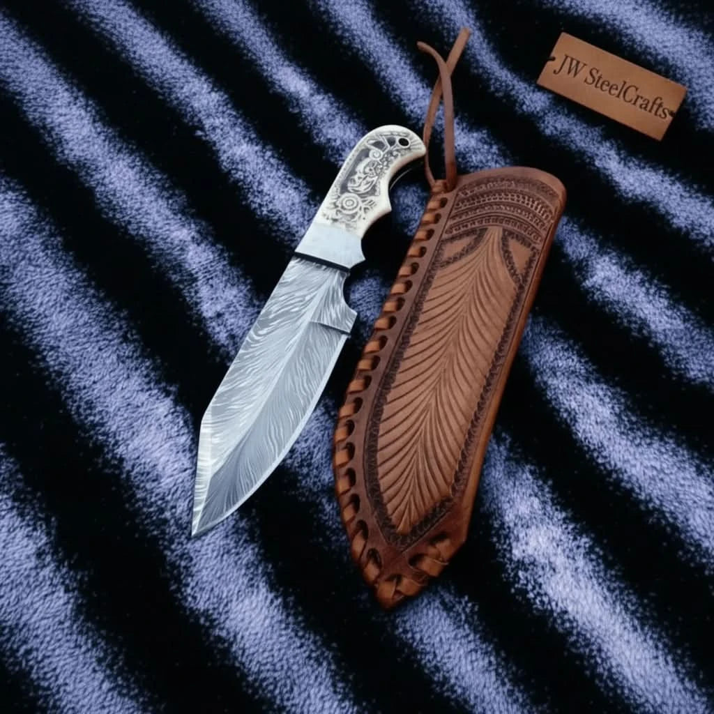 Artisan Damascus knife with engraved bone grip, decorative mosaic pins, silver bolster, and patterned steel blade.