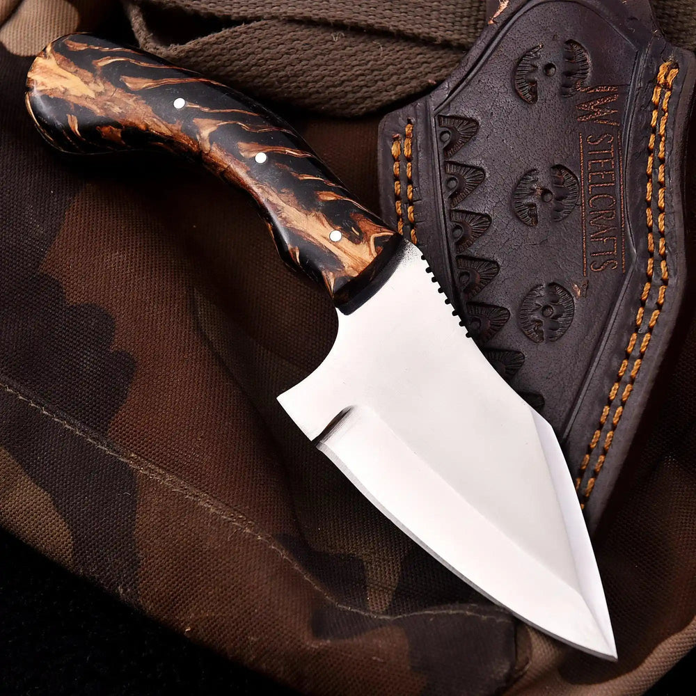 Angular steel blade handmade tactical knife featuring a patterned dark resin handle and serrated thumb grip area.