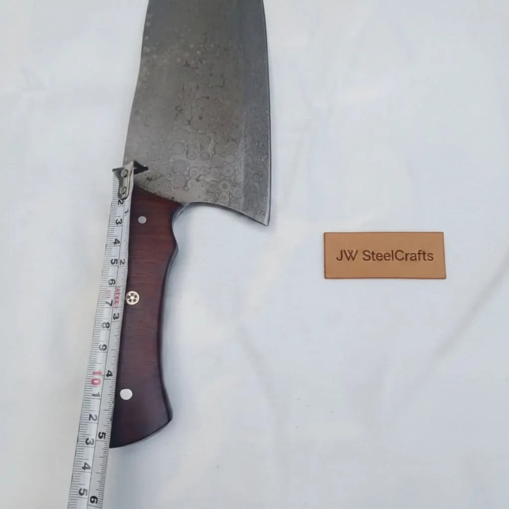 Size reference cleaver knife with wooden handle and patterned blade displayed with tape measure